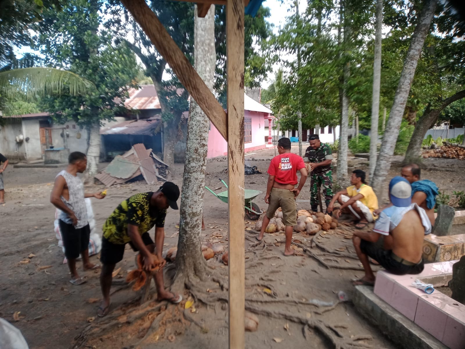 Babinsa Koramil 1505-01/Tidore Bantu Warga Kupas Kelapa untuk Tahlilan di Kelurahan Rum